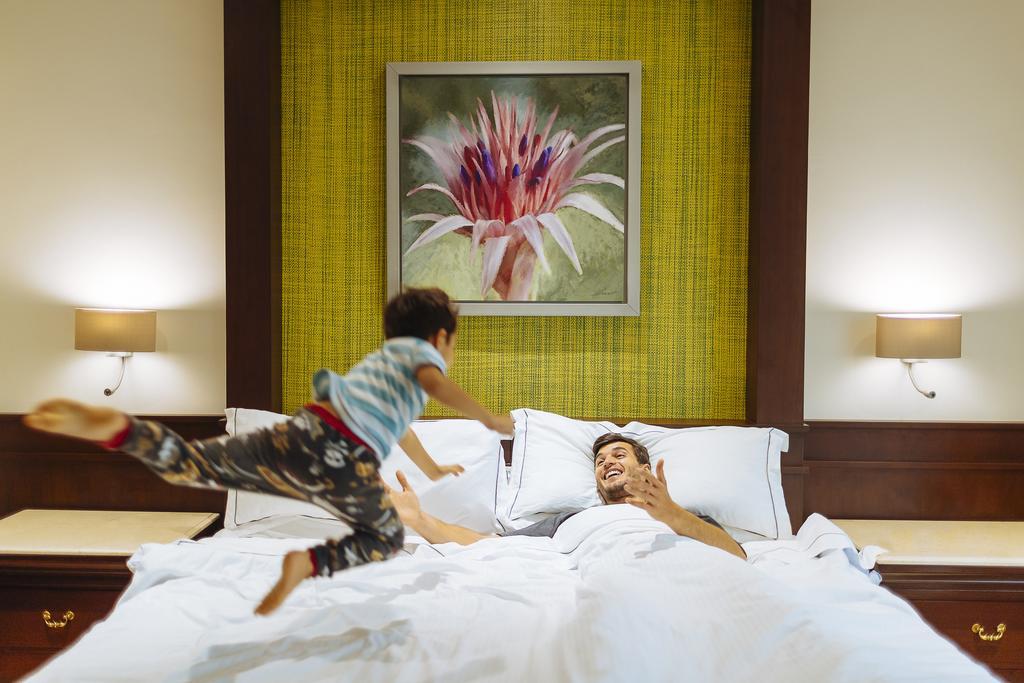 Occidental At Xcaret Destination Hotell Playa del Carmen Eksteriør bilde A child jumps on a bed.